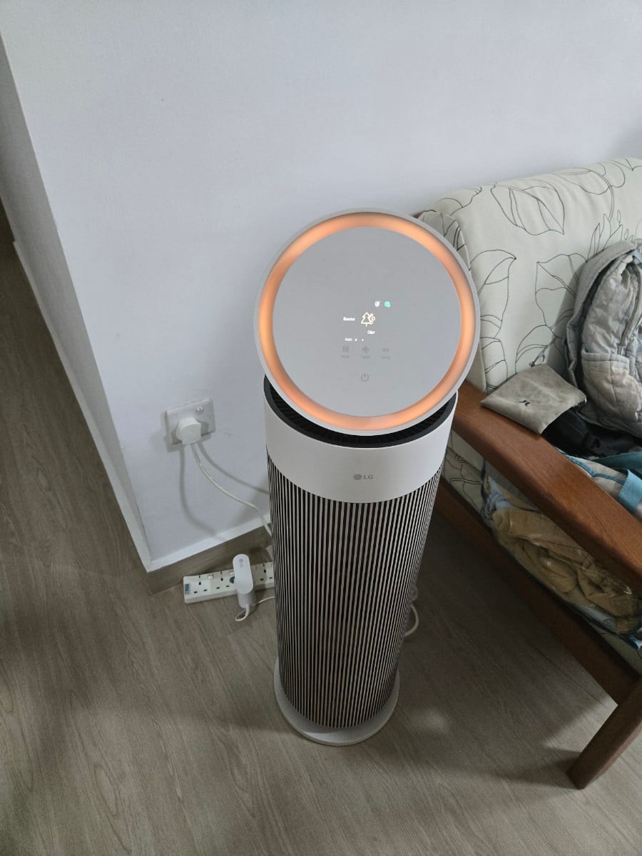 Front view of an LG AeroBooster Air Purifier in a real living room