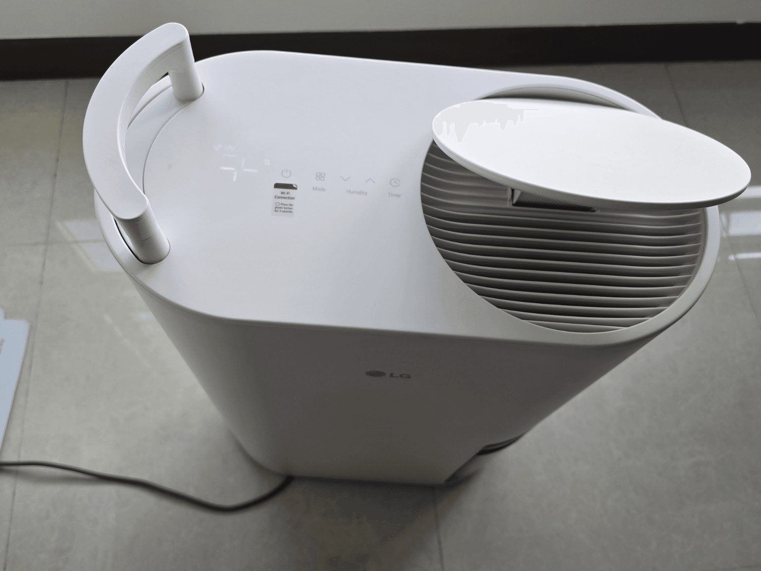 Top controls and air outlet of an LG Dual Inverter Dehumidifier
