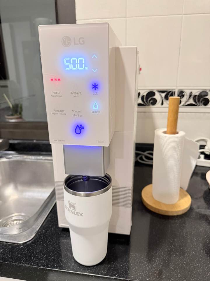 LG water purifier dispensing into a tumbler in a real kitchen