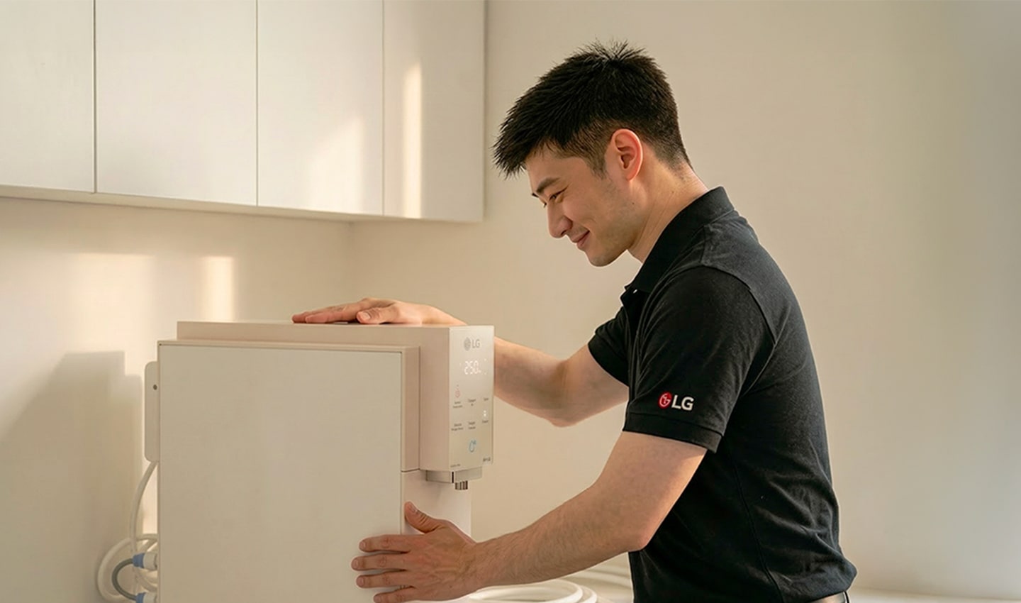 LG professional installing a water purifier in a kitchen